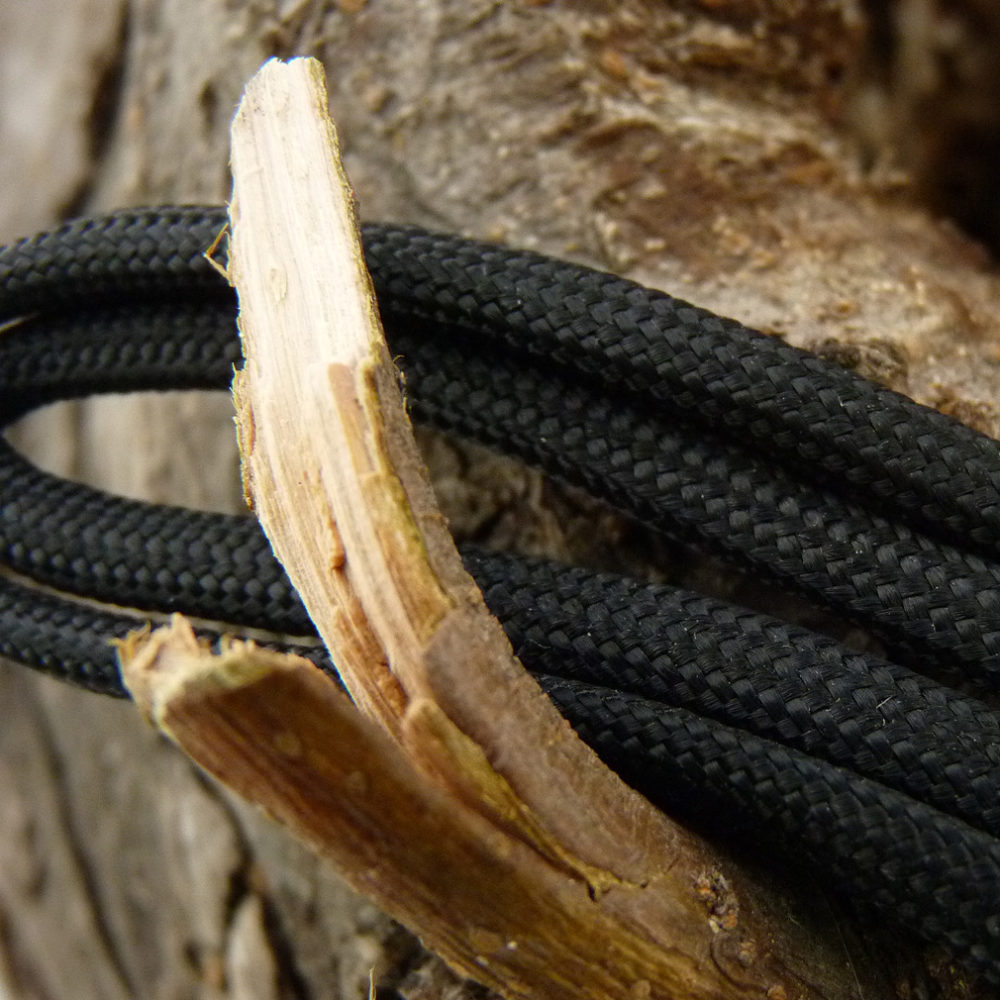 Paracord Black Strands Across Wood1 1010 X 1010 Dakota Gear